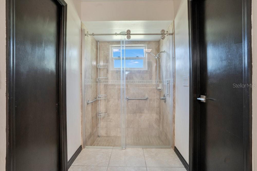 2088 Golden Arm Road Deltona, FL 32738 - Photo 26 of 51 a bathroom with a glass shower door