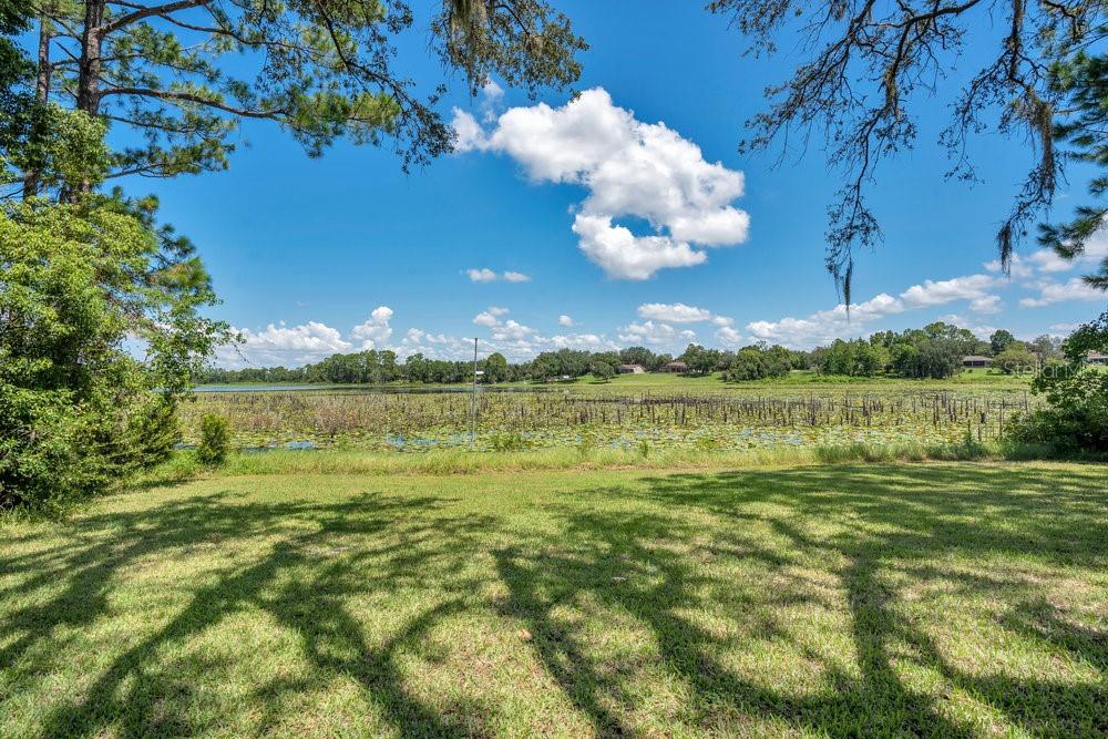 2088 Golden Arm Road Deltona, FL 32738 - Photo 36 of 51 a view of a lake with a building in the background
