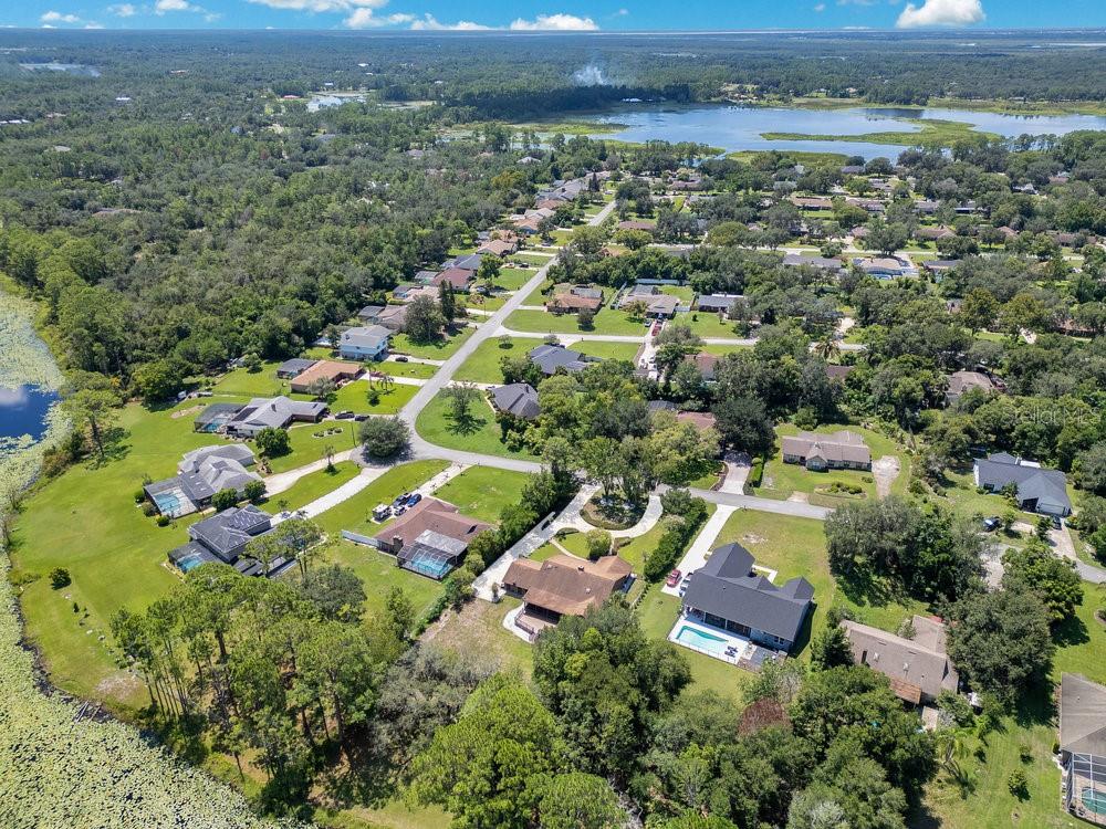 2088 Golden Arm Road Deltona, FL 32738 - Photo 47 of 51 an aerial view of residential houses with outdoor space and trees