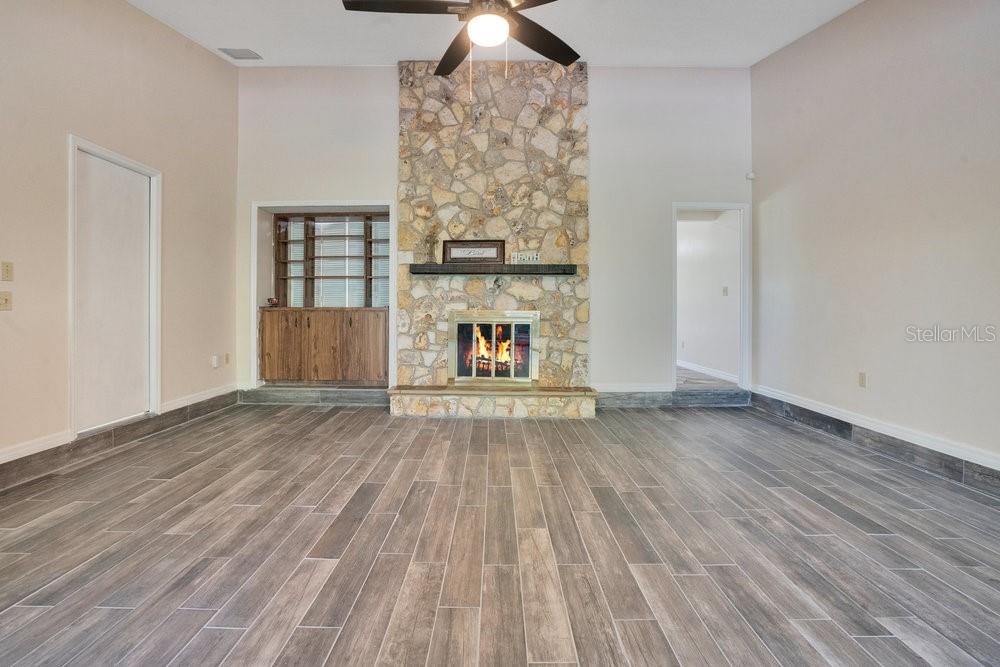 2088 Golden Arm Road Deltona, FL 32738 - Photo 7 of 51 a view of empty room with wooden floor and fireplace