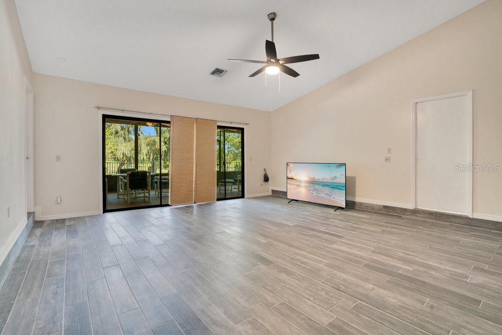 2088 Golden Arm Road Deltona, FL 32738 - Photo 8 of 51 a view of an empty room with wooden floor and a window
