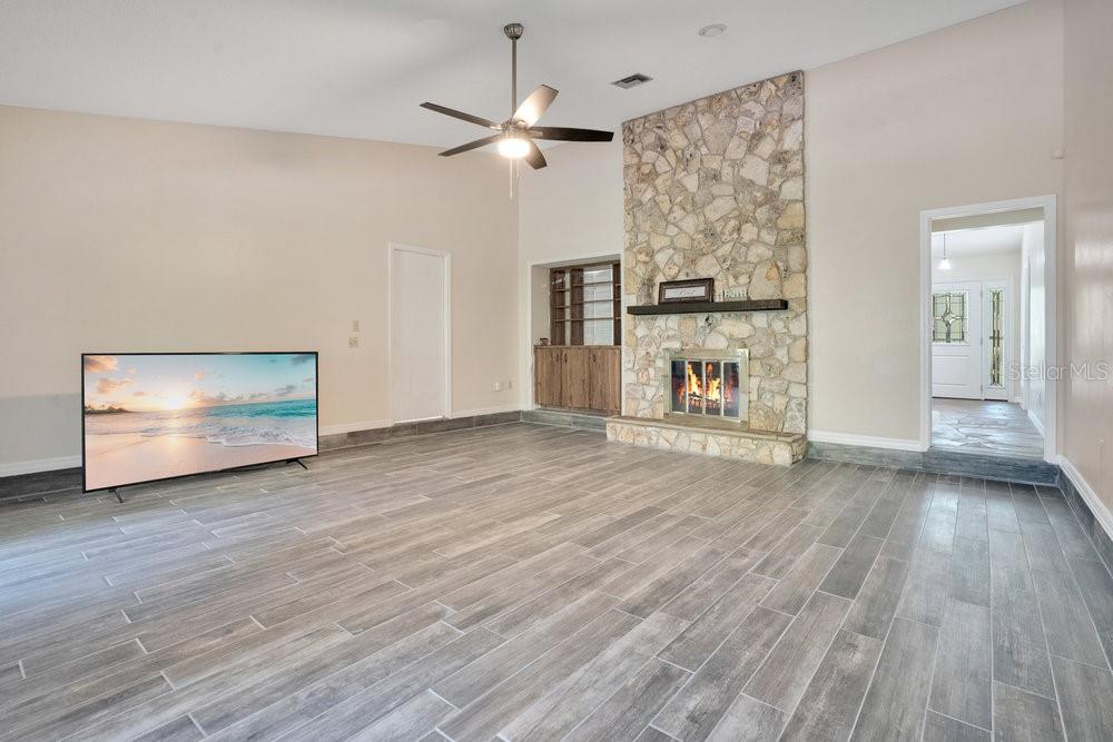2088 Golden Arm Road Deltona, FL 32738 - Photo 9 of 51 an empty room with wooden floor chandelier and windows