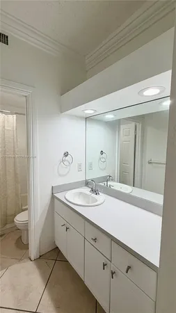 a spacious bathroom with a double vanity sink and a mirror