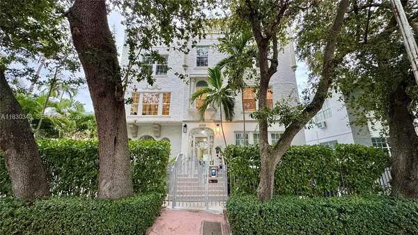 front view of a house with a tree