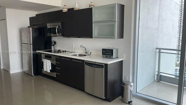 a kitchen with stainless steel appliances a refrigerator and a microwave