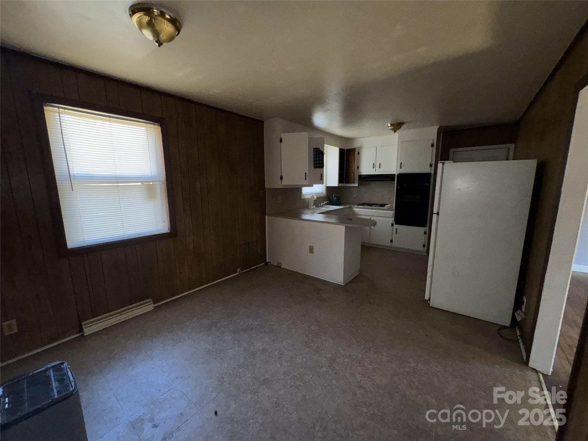 2724 Mary Avenue Gastonia, NC 28052 - Photo 12 of 21 a view of a kitchen with fridge and wooden floor