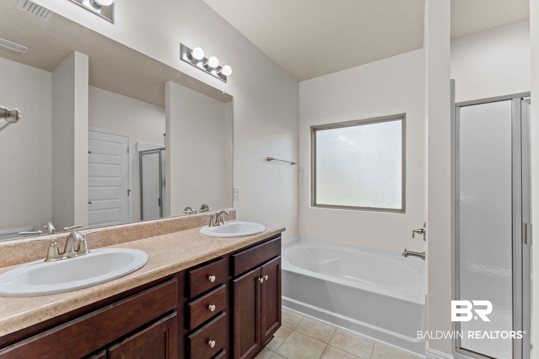 1464 Surrey Loop Foley, AL 36535 - Photo 17 of 24 Bathroom featuring a stall shower, a bath, double vanity, and tile patterned flooring