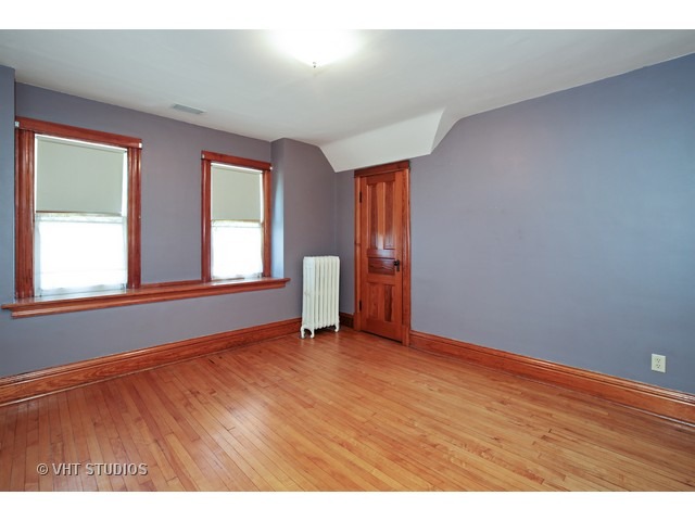 721 North Spring Street Elgin, IL 60120 - Photo 11 of 16 an empty room with wooden floor and windows