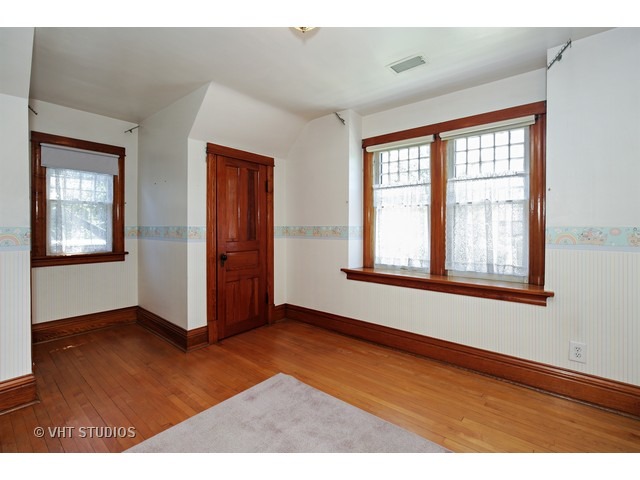 721 North Spring Street Elgin, IL 60120 - Photo 13 of 16 a view of an empty room with window and wooden floor