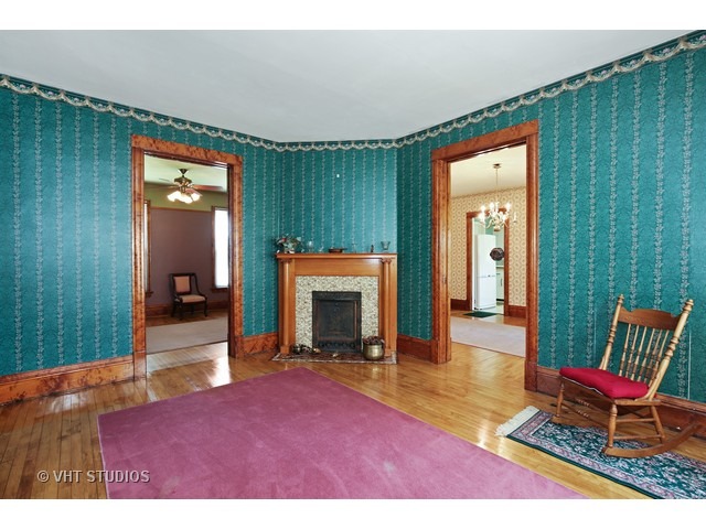 721 North Spring Street Elgin, IL 60120 - Photo 5 of 16 a living room with a fireplace furniture and a window