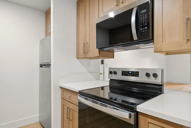 a kitchen with stainless steel appliances a sink cabinets and a microwave
