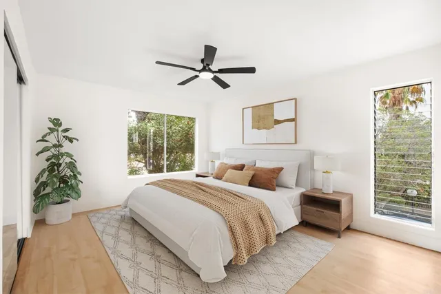 a bedroom with a large bed and a window