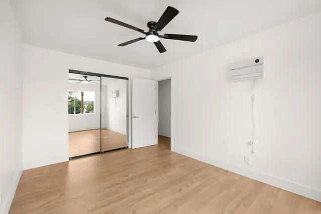 a view of a big room with windows and closet