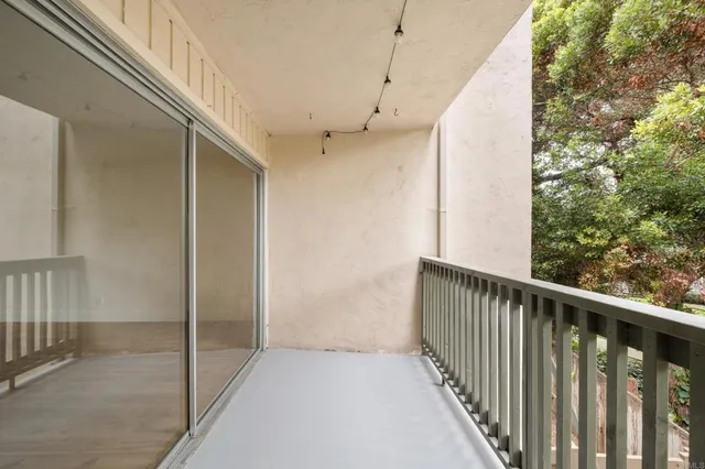 a view of an empty room with a kitchen
