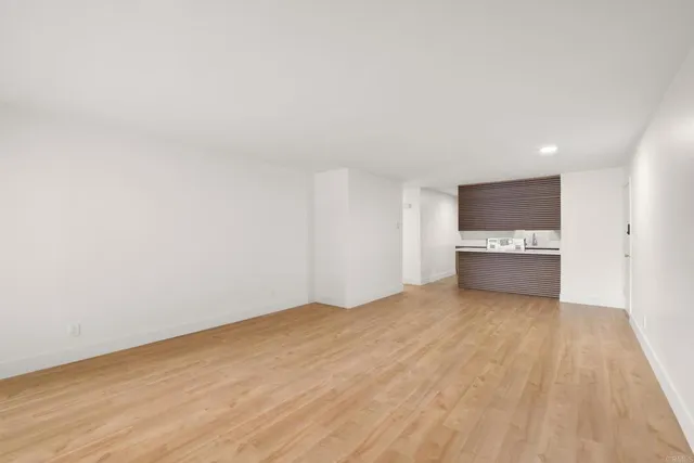 a view of a kitchen with wooden floor