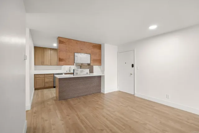 a kitchen with white cabinets and sink