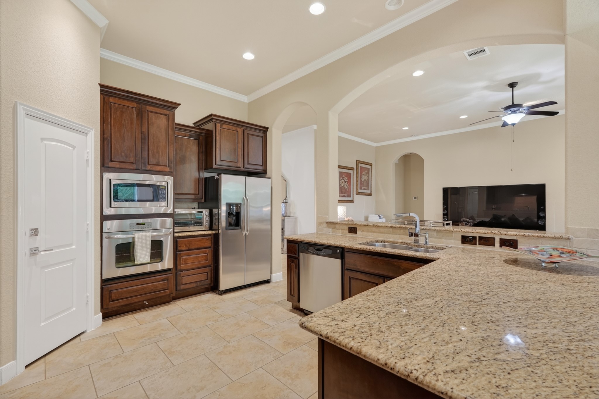 55 South Victoriana Circle Spring, TX 77389 - Photo 18 of 40 a kitchen with stainless steel appliances a stove sink and microwave