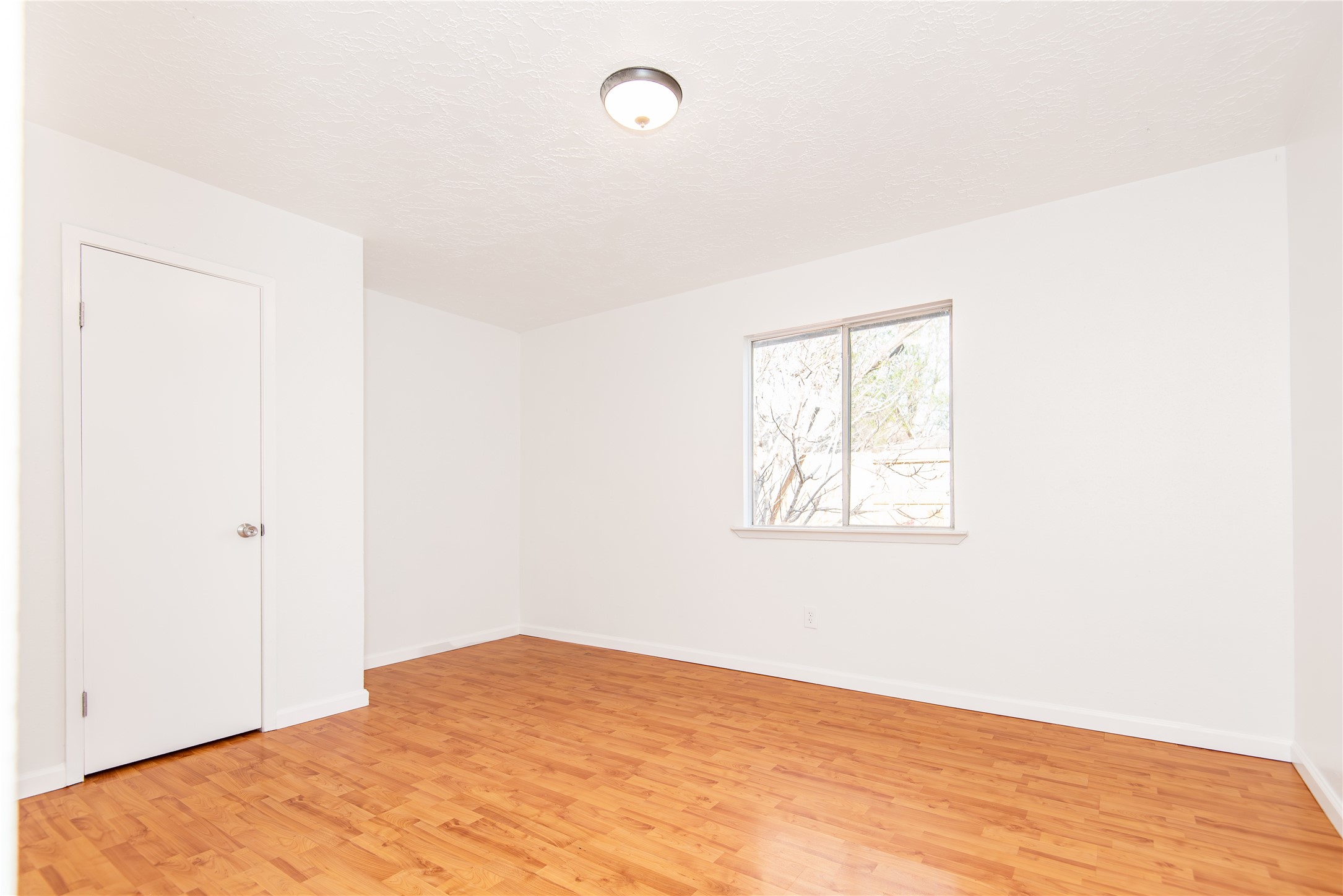 21734 Nickerton Lane Spring, TX 77388 - Photo 27 of 31 a view of an empty room with wooden floor and a window