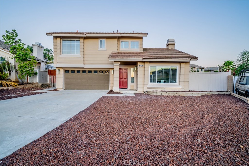 26783 Eagle Run Street Corona, CA 92883 - Photo 2 of 2 a front view of a house with a yard and garage