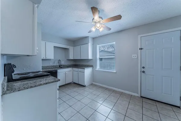 a kitchen with a refrigerator and cabinets