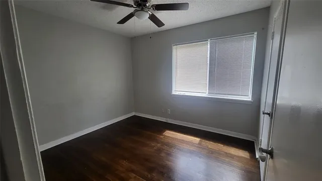 a view of a room with wooden floor and windows