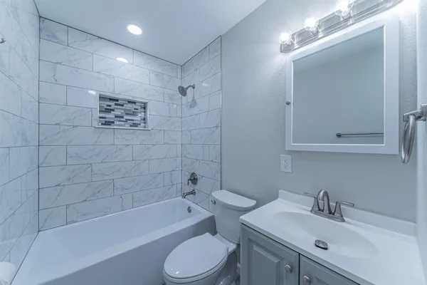 a bathroom with a sink toilet and shower