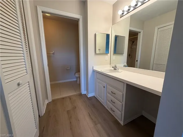 a bathroom with a double vanity sink and mirror