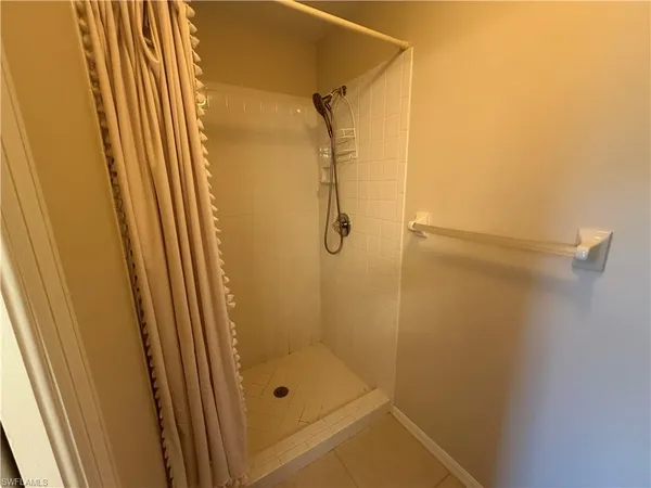 a bathroom with a glass shower door and sink