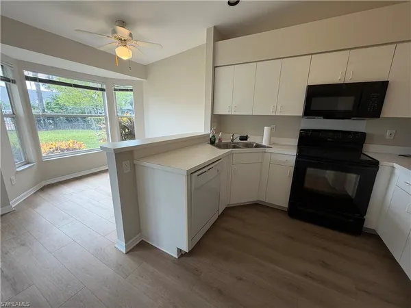 a kitchen with stainless steel appliances a stove a sink and a microwave