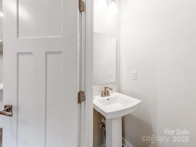 a view of a livingroom with wooden floor and a flat screen tv
