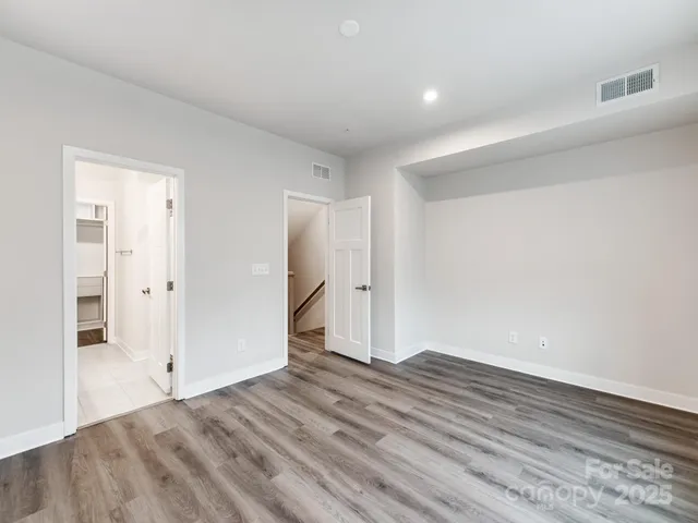 a bathroom with a double vanity sink a mirror and a toilet