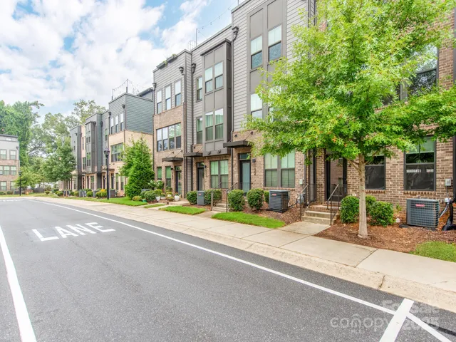 a front view of a house with a garden and plants