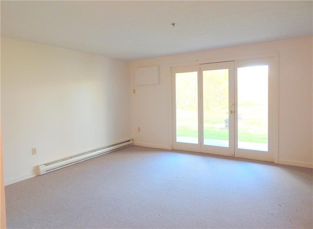 574 Main Street, Unit 102 Damariscotta, ME 04543 - Photo 7 of 27 Living room with ground level exit...