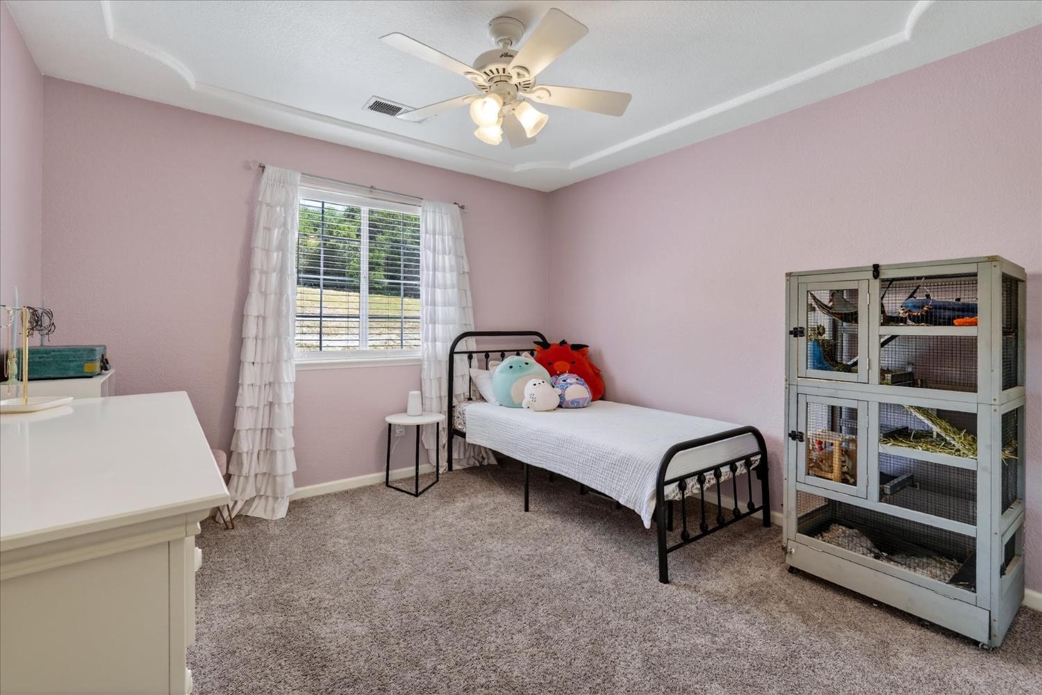 47482 Veater Ranch Road Coarsegold, CA 93614 - Photo 27 of 51 a bedroom with a bed and a book shelf