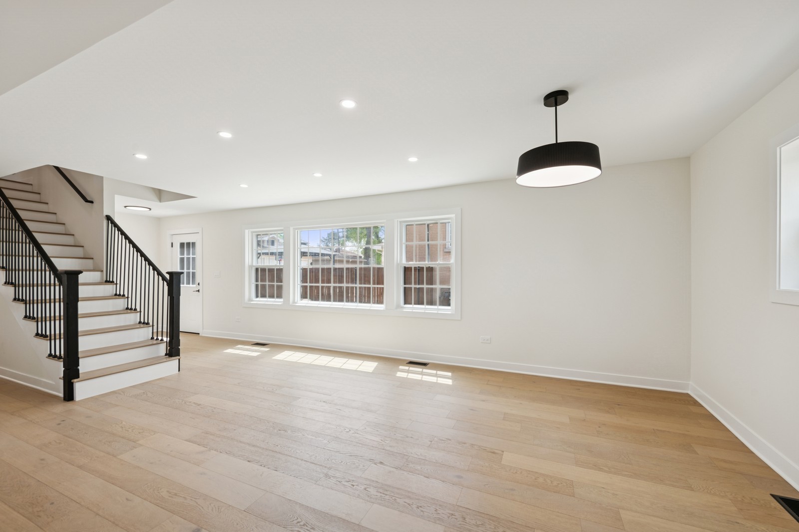 1929 South Ashland Avenue Park Ridge, IL 60068 - Photo 5 of 18 a view of an empty room with a window and wooden floor