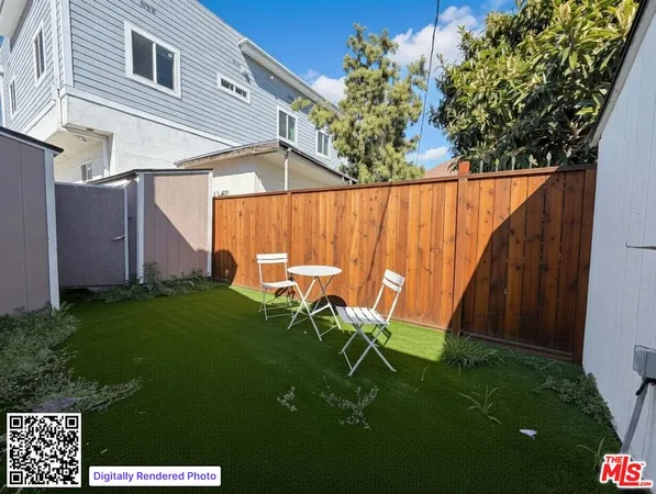 a backyard of a house with table and chairs