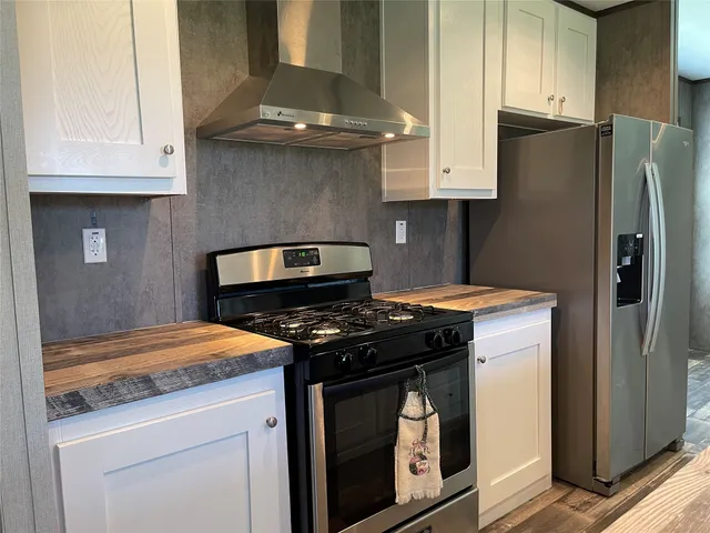 a kitchen with stainless steel appliances granite countertop a stove and a refrigerator