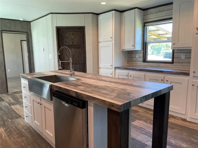a kitchen with a stove a sink and a refrigerator