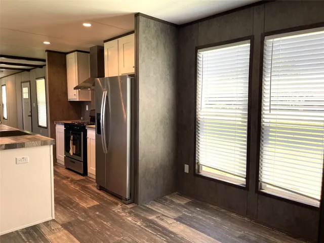 a kitchen with stainless steel appliances granite countertop a refrigerator and a sink