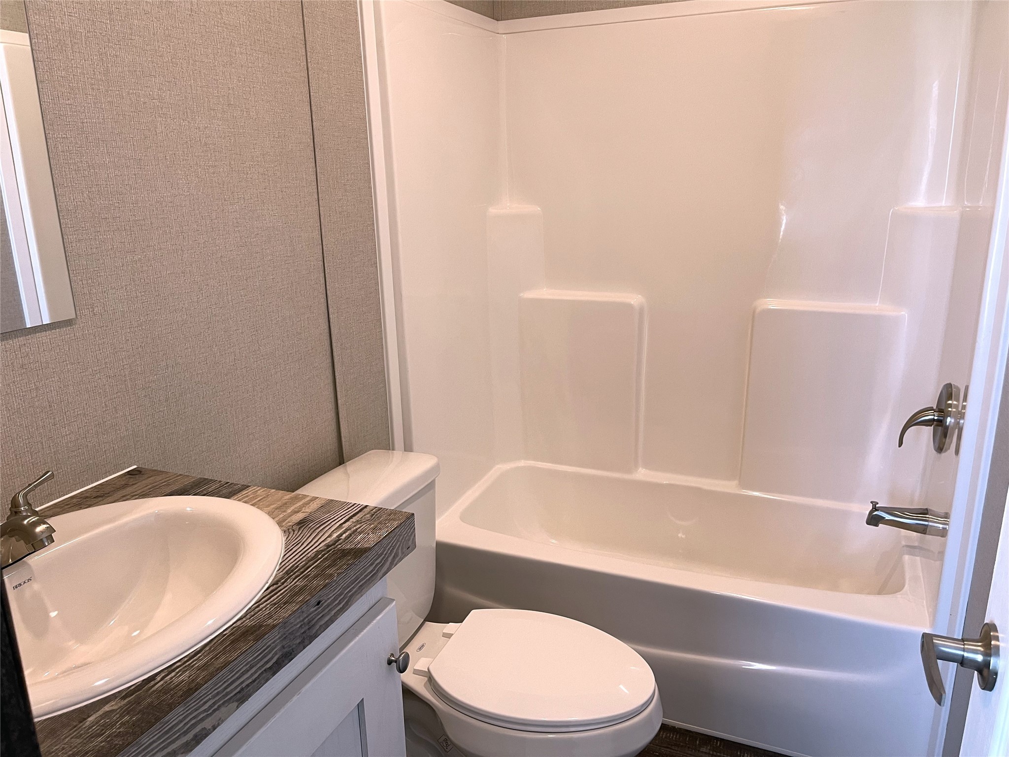 322 College Street Fairfield, TX 75840 - Photo 25 of 34 a bathroom with a granite countertop toilet sink and mirror