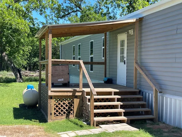 a view of a house with backyard porch and wooden floor