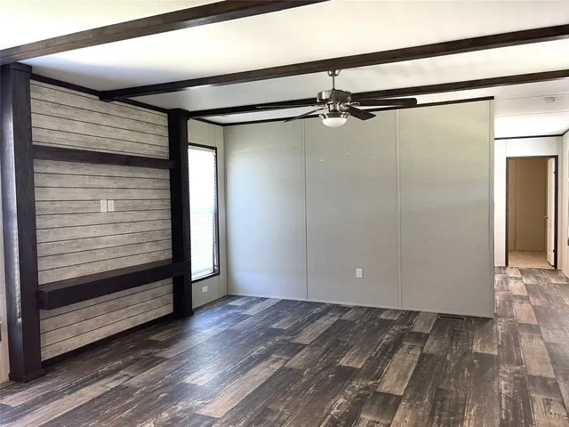 a view of a room with wooden floor
