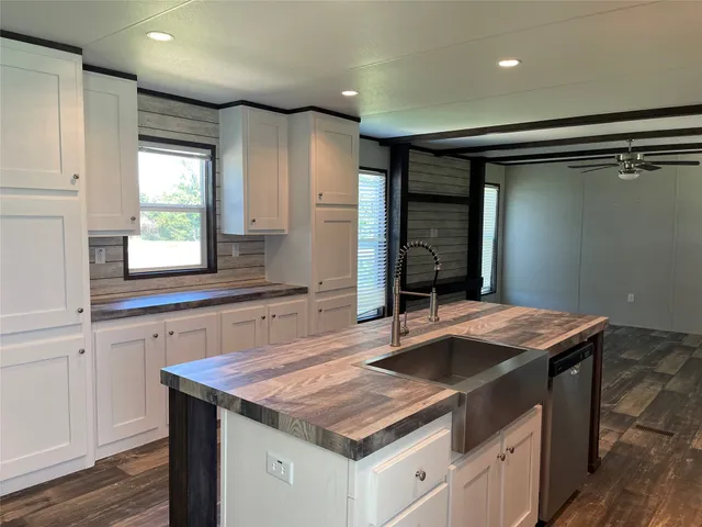 a kitchen that has a sink a window and stainless steel appliances