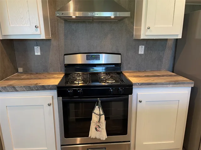 a stove top oven sitting inside of a kitchen