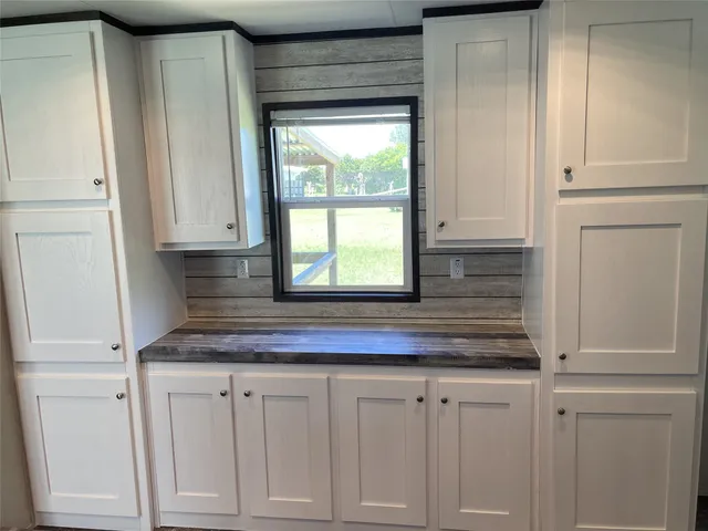 a kitchen with granite countertop white cabinets and a granite counter tops