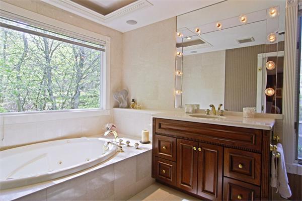 71 Donna Road Newton, MA 02459 - Photo 11 of 17 a spacious bathroom with a tub sink and mirror
