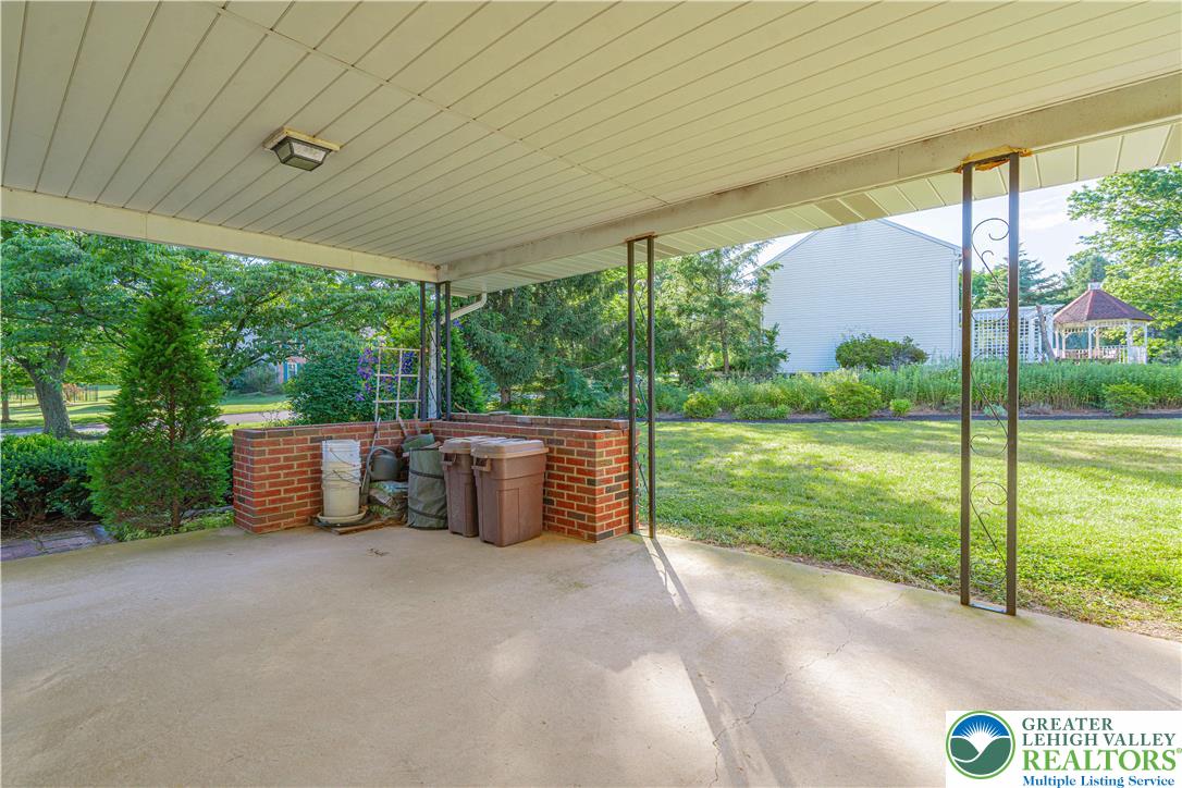 5425 Clauser Road Orefield, PA 18069 - Photo 9 of 18 A well-lit covered patio offers a pleasant spot to relax overlooking the manicured yard.