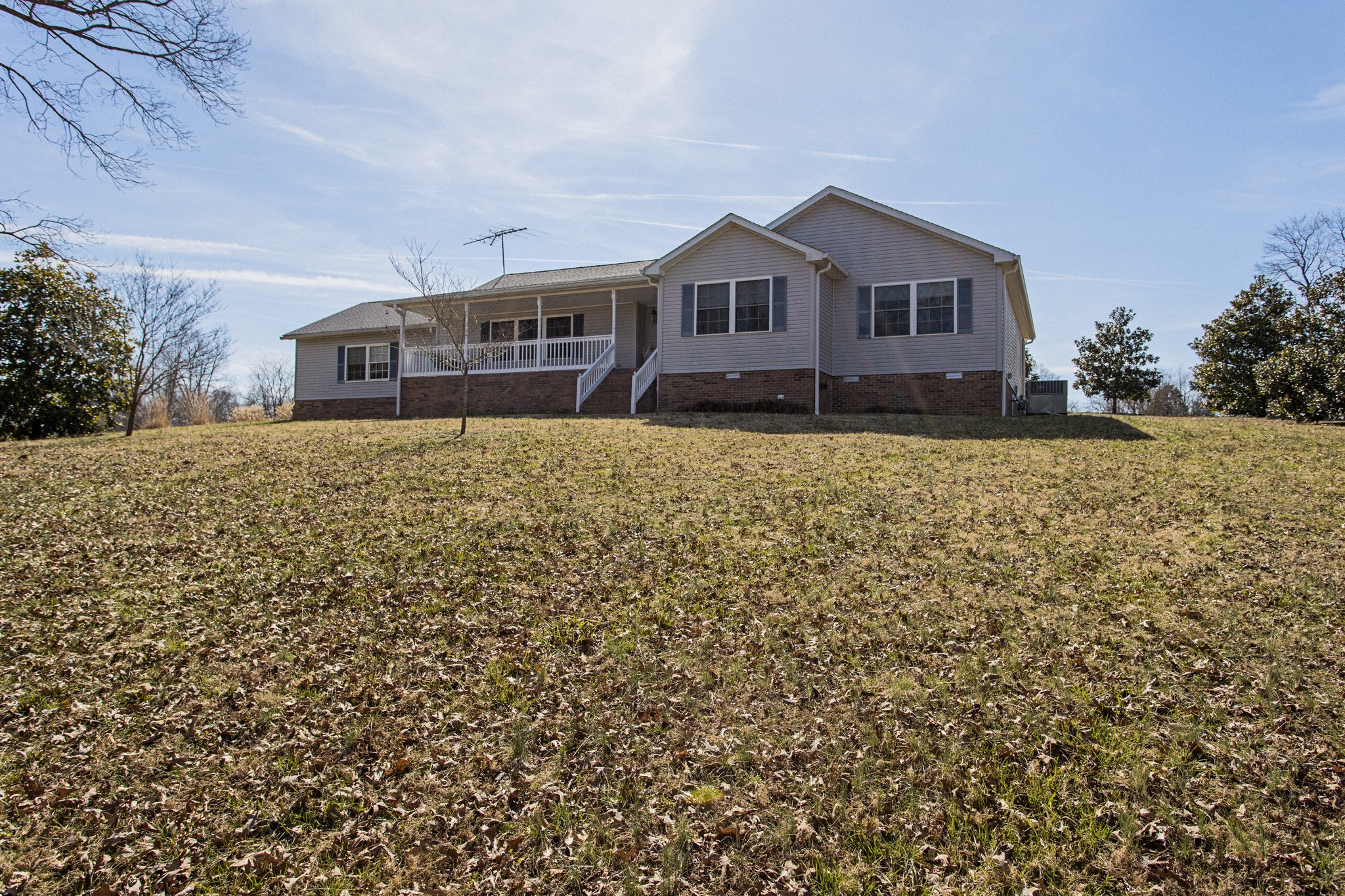 3579 Kinneys Road Cedar Hill, TN 37032 - Photo 17 of 26 a front view of a house with a yard