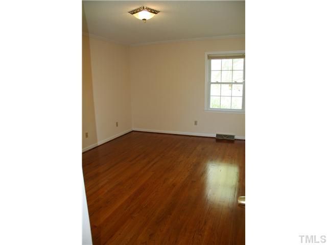 3221 Manor Ridge Drive Raleigh, NC 27603 - Photo 12 of 20 a view of a room with wooden floor and a window