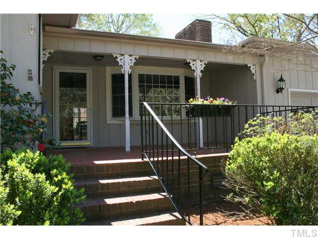 3221 Manor Ridge Drive Raleigh, NC 27603 - Photo 18 of 20 a view of a house with a small yard and potted plants